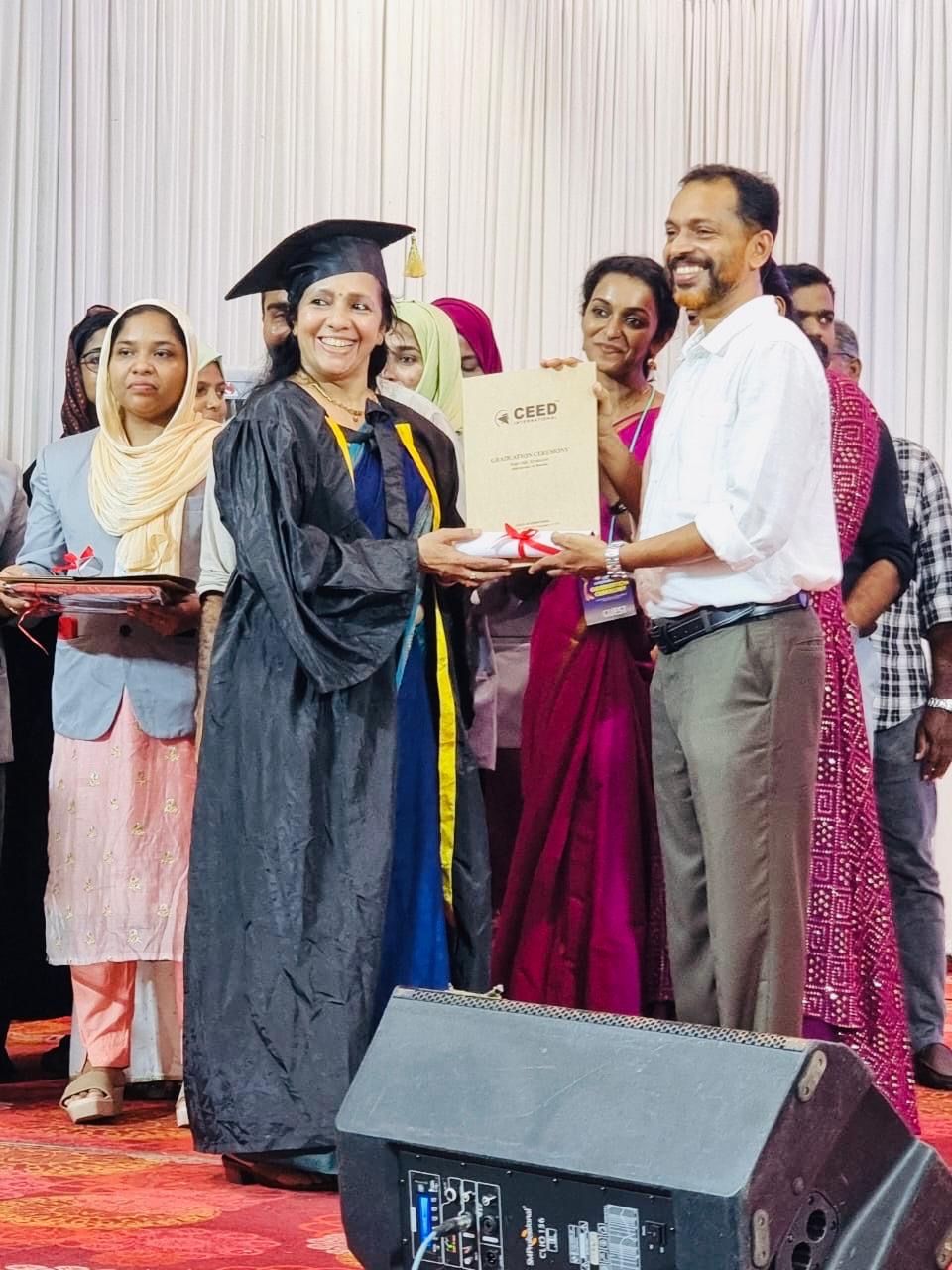 Sobhana PS receiving her yoga certification at CEED graduation ceremony